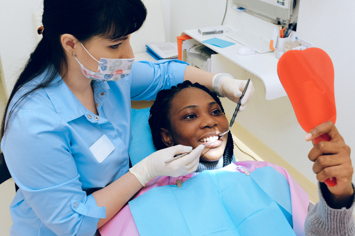 Periodontist explaining deep cleaning and regular dental cleaning to a patient.